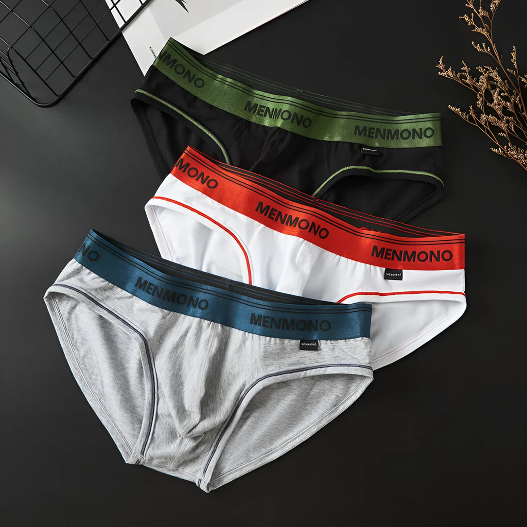 Men's low-waist cotton briefs in a two-tone colour on a solid background.
