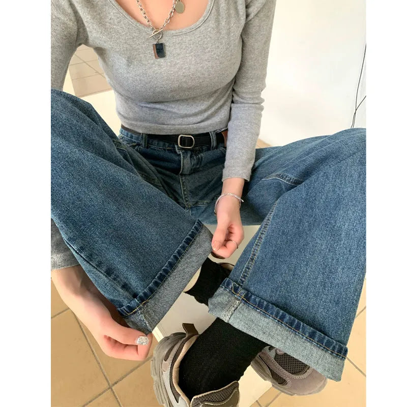 Women's high waist straight leg jeans in retro blue denim, shown on a model.