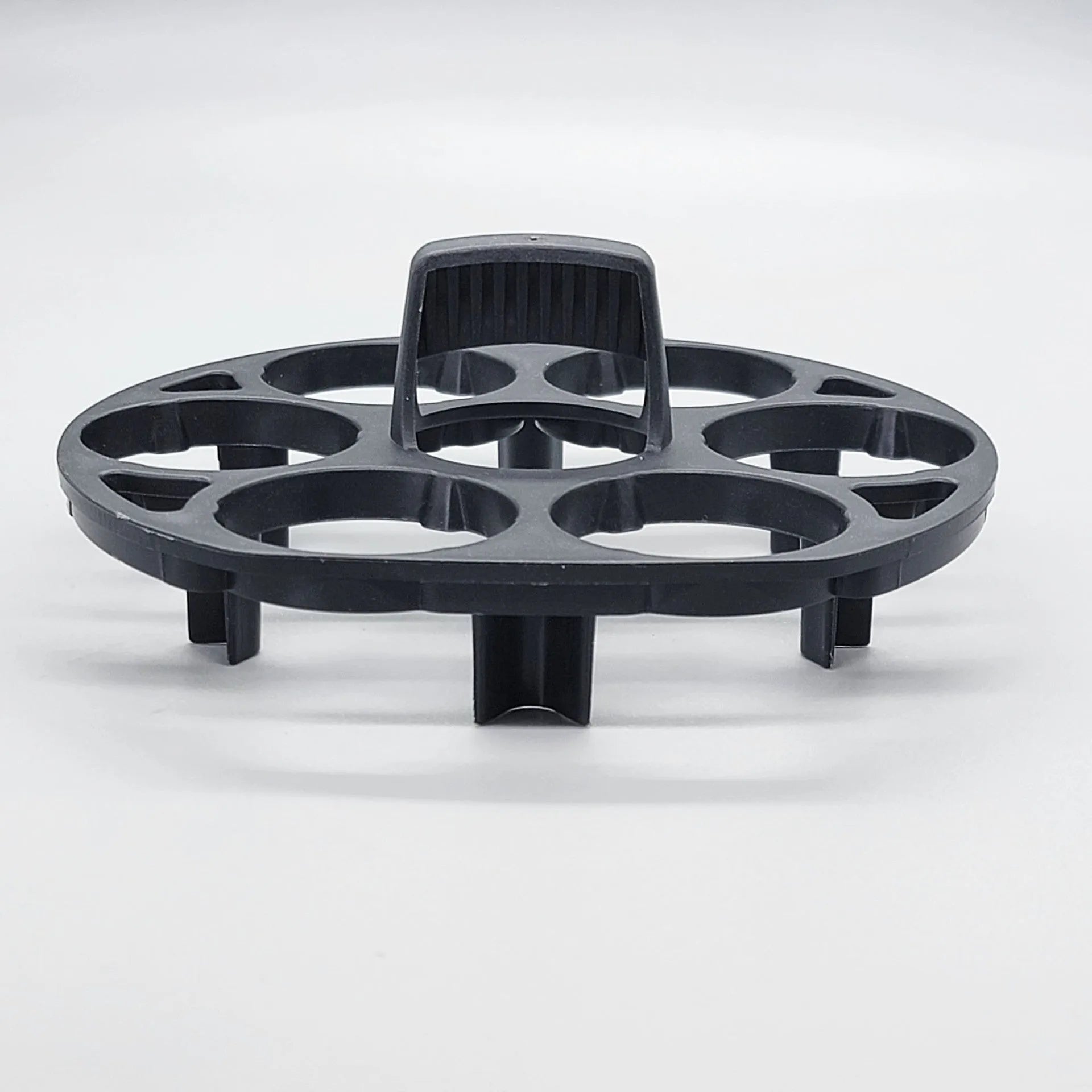 Black modern plastic egg holder rack on a kitchen surface.