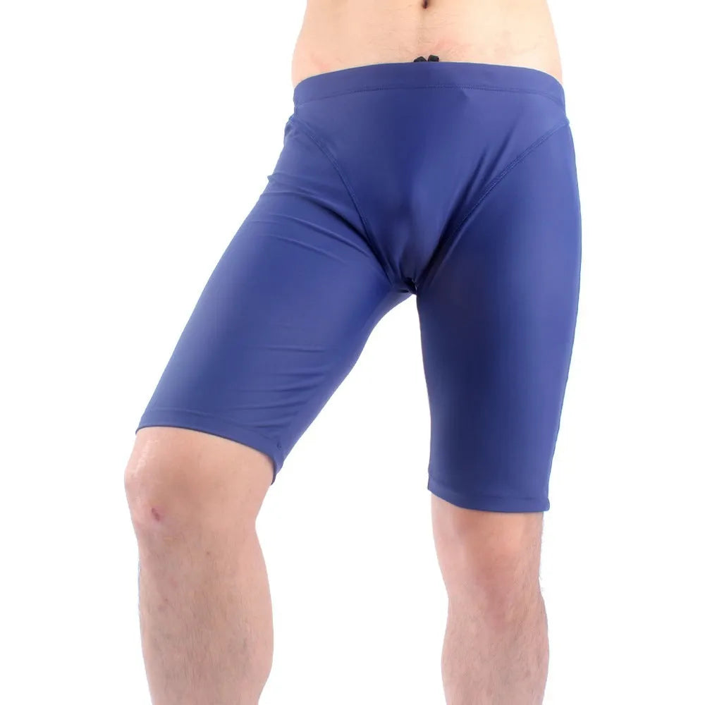 Men's green quick-drying nylon swimming trunks with loose five-point fit on a white background