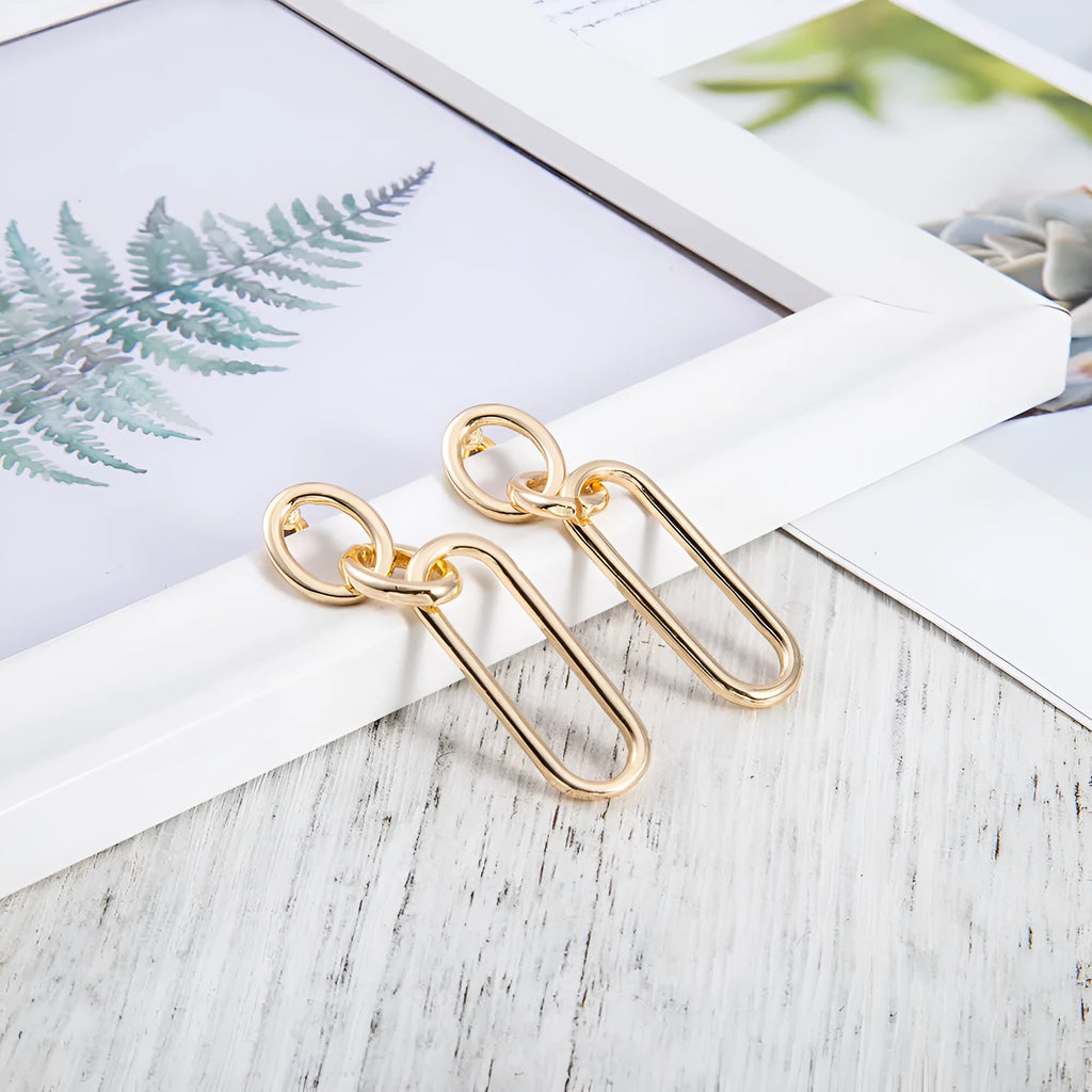 Women's sterling silver colour geometry hoop earrings showing ring and line design elements