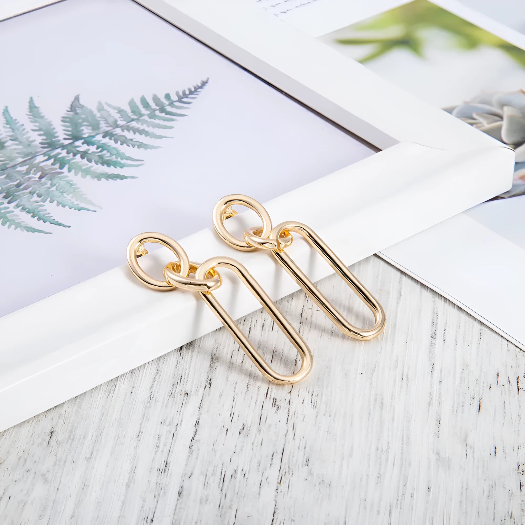 Women's sterling silver colour geometry hoop earrings showing ring and line design elements