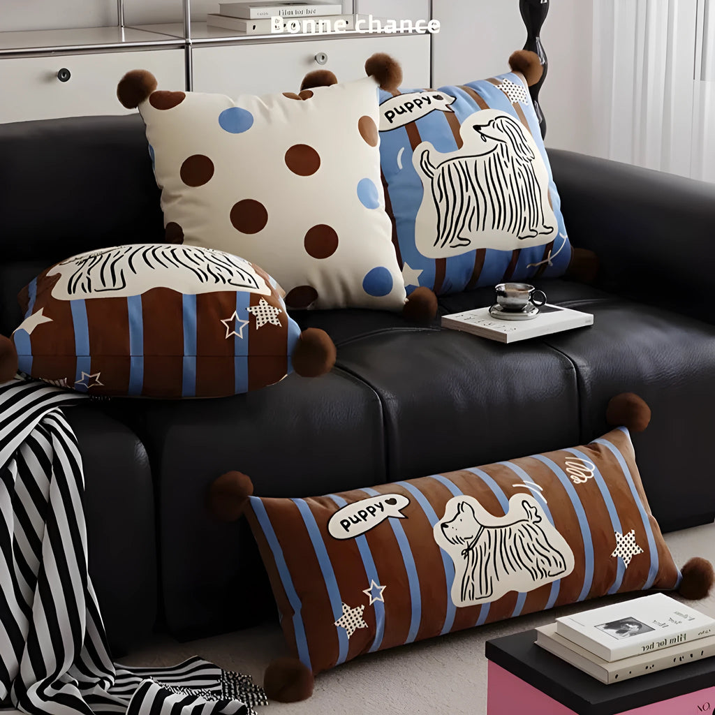Cartoon printed cushion pillow with cute animal design on a sofa, showing blue colour and square shape.