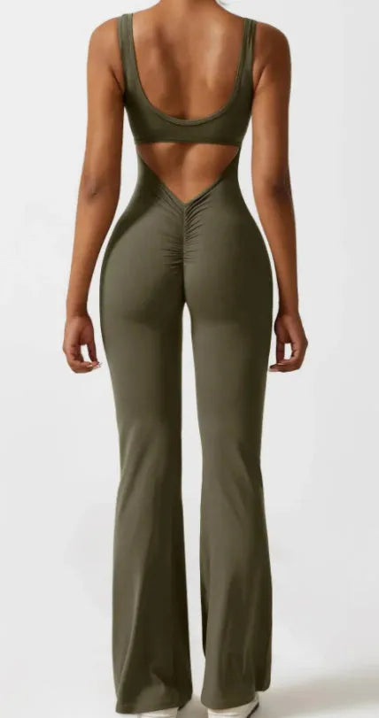 Black seamless women's yoga bodysuit jumpsuit with built-in chest pad, shown on model.