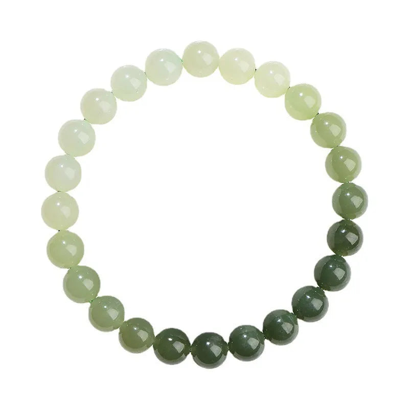 Natural clear water Hetian jade bracelet showing gradient colour on round beads and barrel beads.
