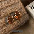 Handmade geometric alloy earrings with tassel details in three styles: round piece, irregular amber, and water drop tiger eye studs