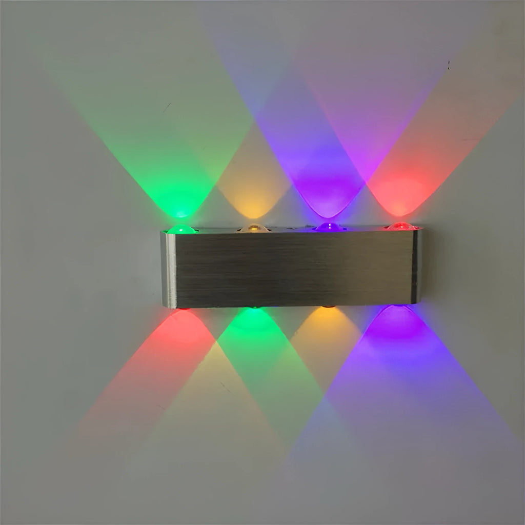 Silver aluminium rectangular LED wall lamp showing seven colour lighting options on bedroom wall