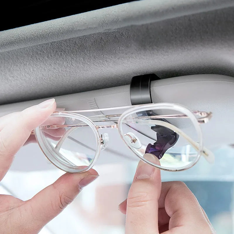Black plastic clip for mounting glasses and cards on a car sun visor