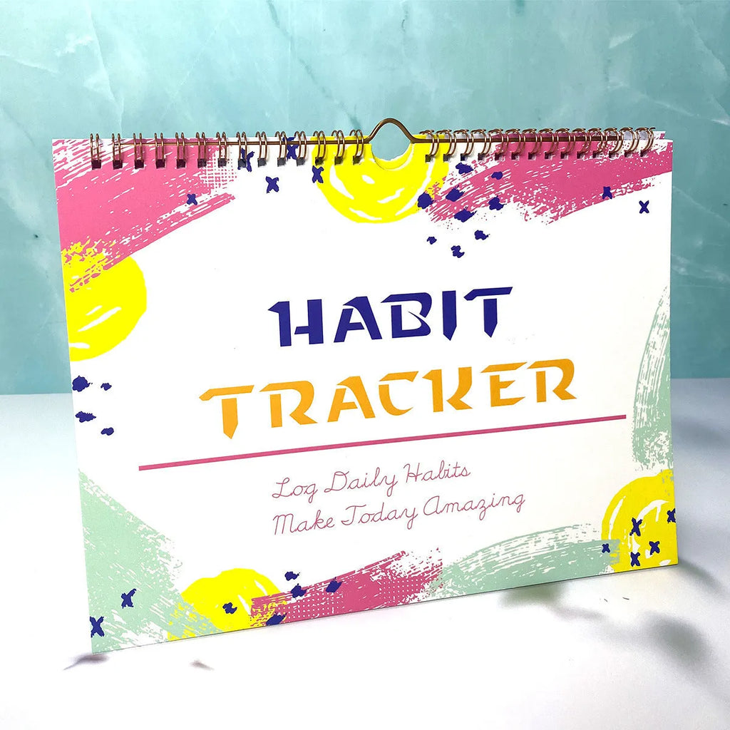 A5 habit tracking notebook in open position showing internal pages, with a choice of pink, purple, floral, or yellow and white covers.