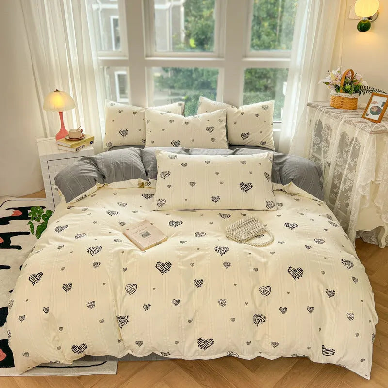 Aerobic jacquard cloud yarn four-piece bedding set with quilt cover, sheet, and pillowcases in a soft pattern.