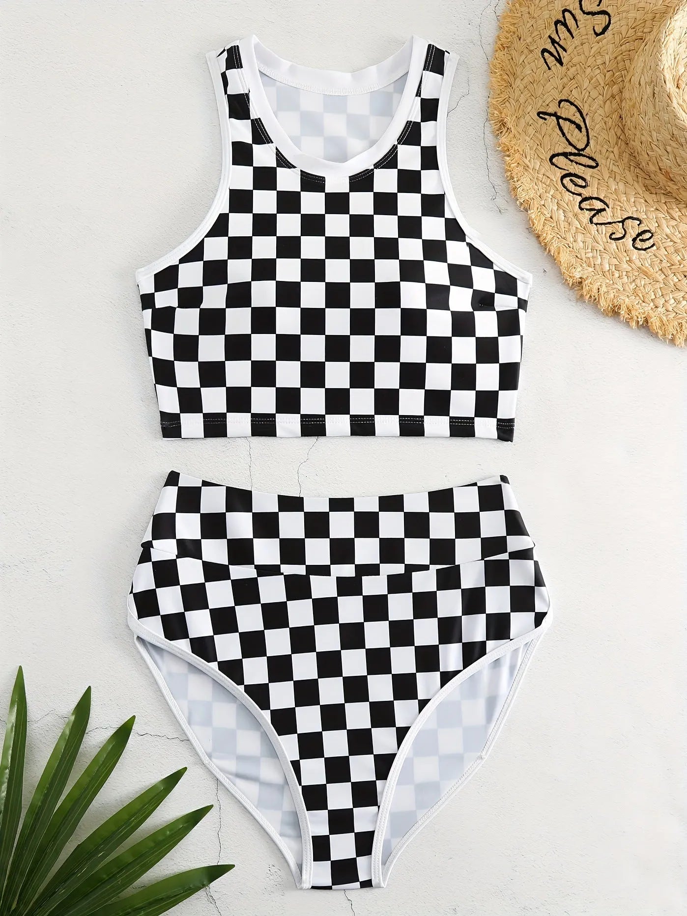 Women's black and white plaid racing one-piece swimsuit with backless design and adjustable suspender straps.