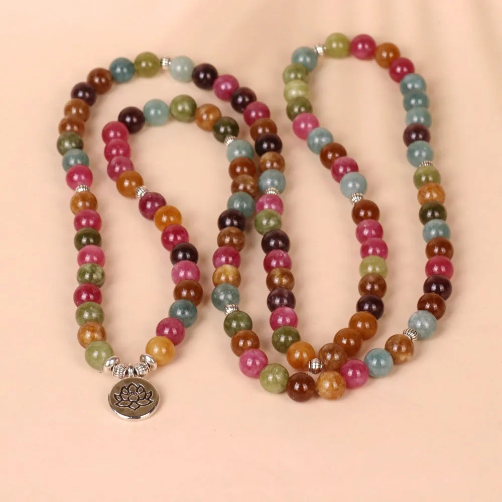108-bead multi-layer bracelet with hanging lotus ornament in tourmaline-coloured alloy.