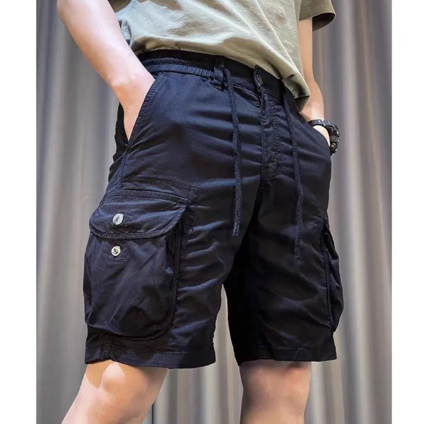 A model wearing loose, straight-leg multi-pocket casual overalls in a khaki colour.