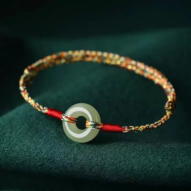 Colourful braided rope bracelet with peace buckle closure on woven design