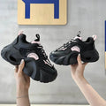 Women's pink casual sneakers with a cross strap, thick sole, and mesh lining on a white background.