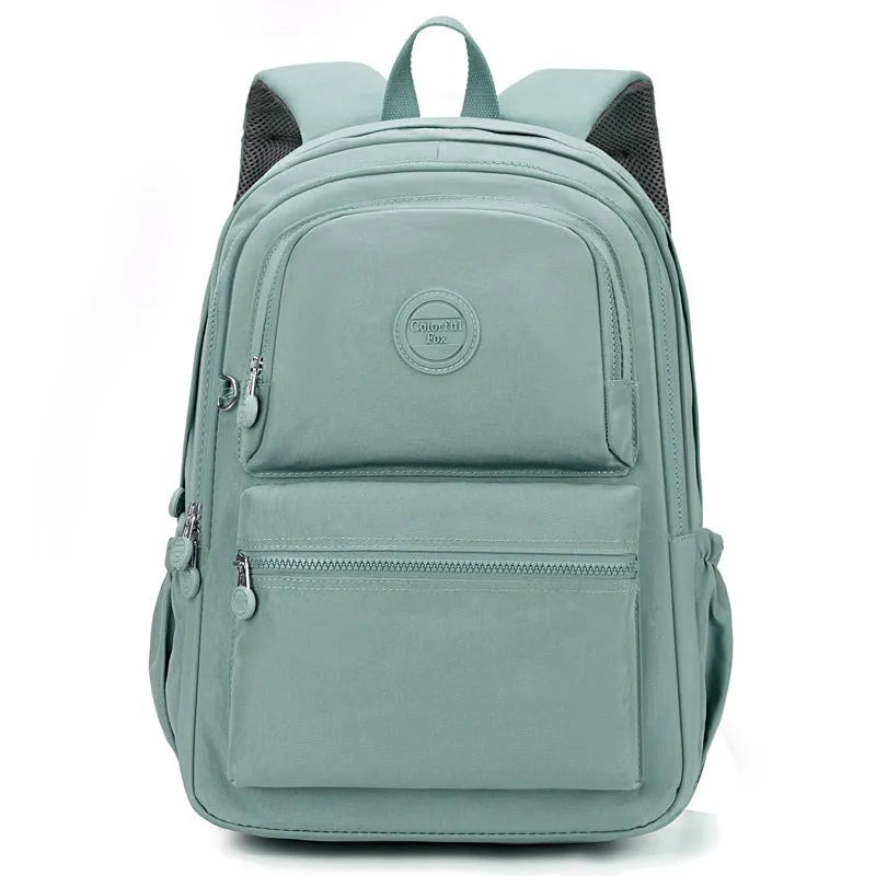 Women's large nylon travel backpack in celestite green showing front three-dimensional pocket and urban style.