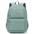 Women's large nylon travel backpack in celestite green showing front three-dimensional pocket and urban style.