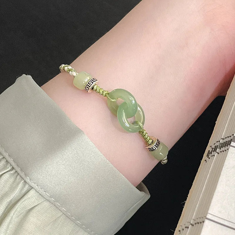 Women's copper bracelet with jade peace buckle and ethnic woven double-ring strap.
