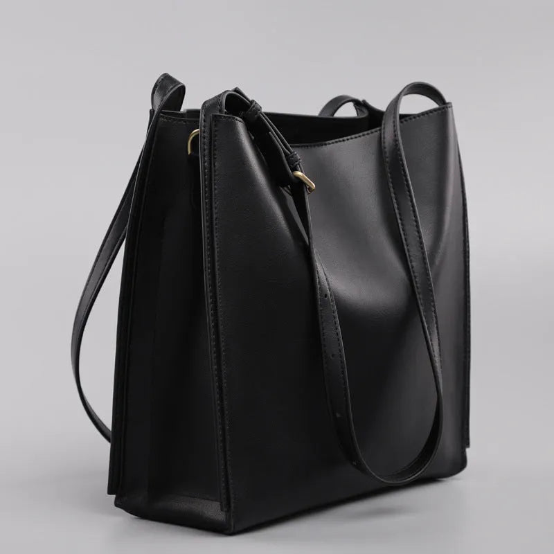 Brown genuine leather women's bucket bag with double shoulder straps and multiple internal organisers