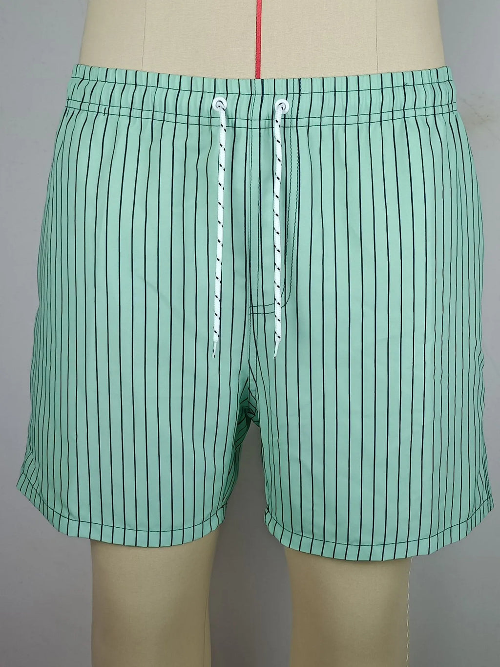 Men's striped polyester shorts in navy blue on a mannequin, showing straight leg design.