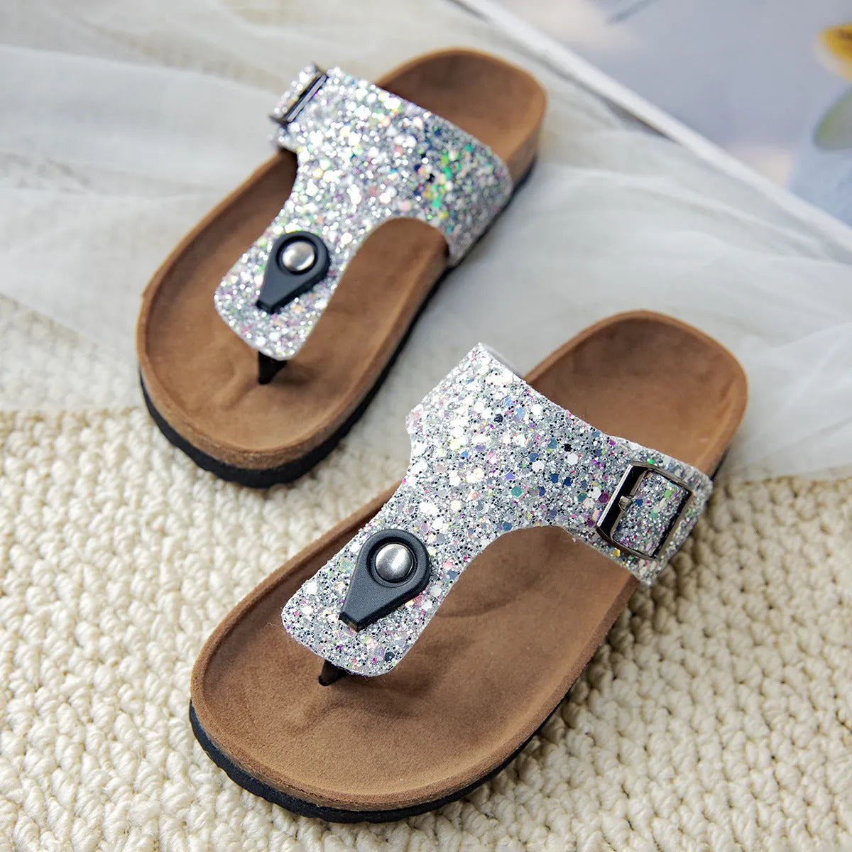 Cork flip-flops in pink, silver, and gold colours with artificial leather uppers and PVC soles