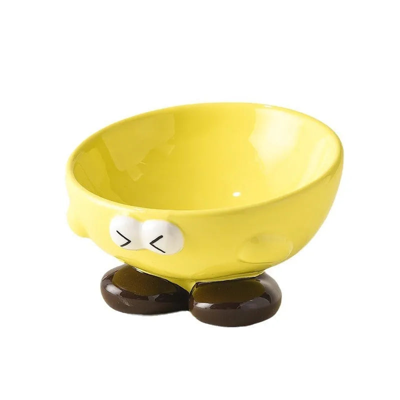 Blue and yellow ceramic slanted pet food bowls with animal face expressions for cervical spine support.