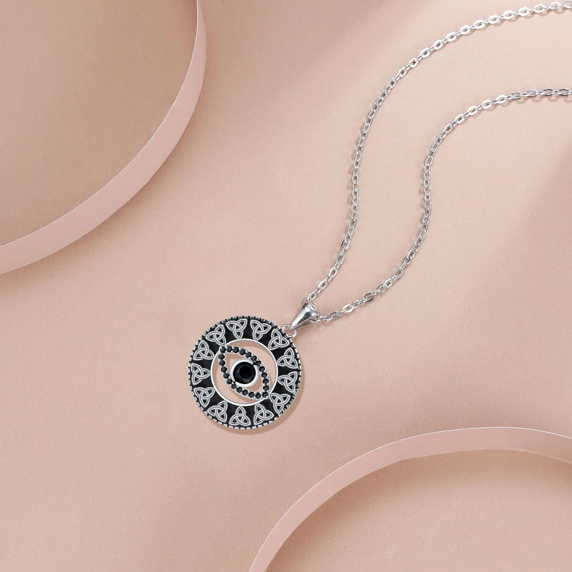 Close-up of a women's copper Devil's Eye pendant necklace on a cross chain, with a light luxury electroplated finish.