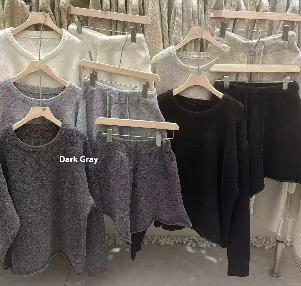 Women's loose-fitting dark grey knitted sweater and wide leg shorts two-piece set.