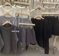 Women's loose-fitting dark grey knitted sweater and wide leg shorts two-piece set.