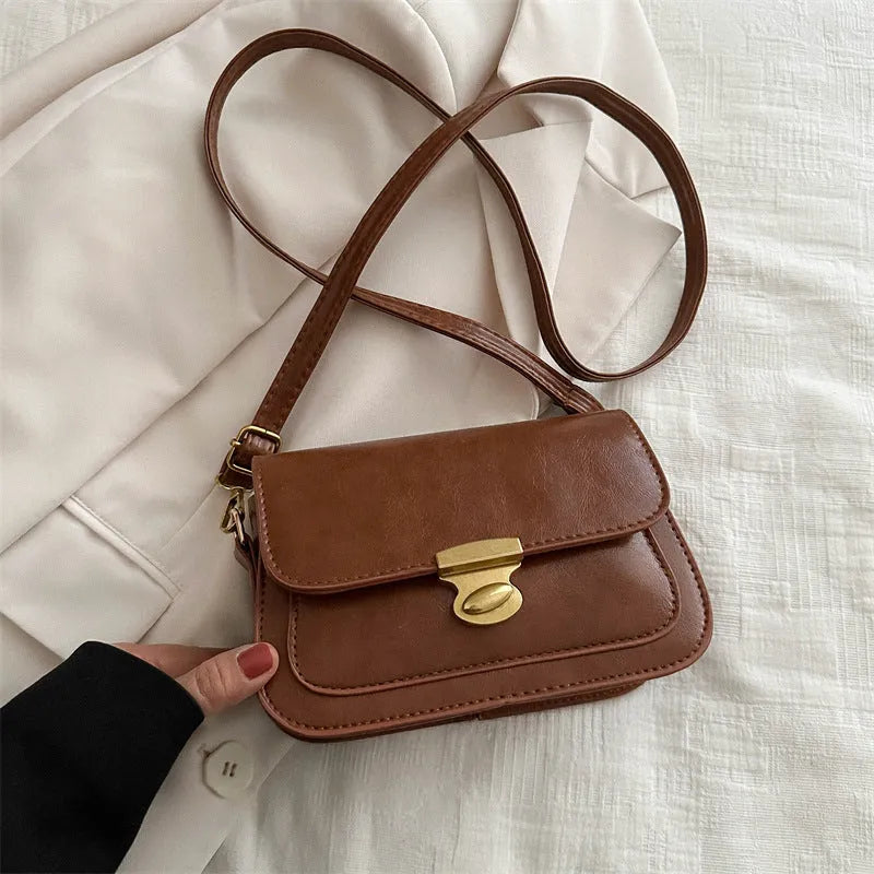 Soft PU leather small square handbag in horizontal rectangle shape shown in brown colour.