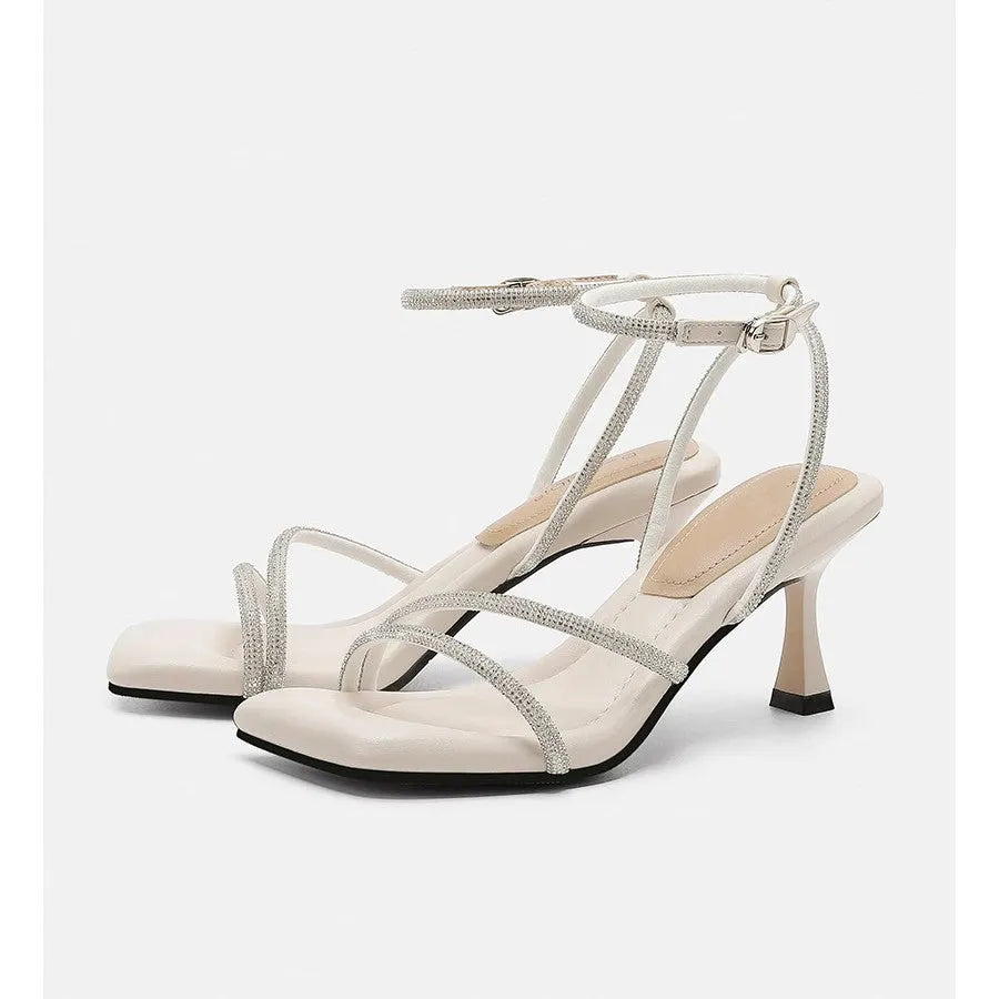 Women's silver square toe rhinestone ankle strap high heel sandals on a white background.