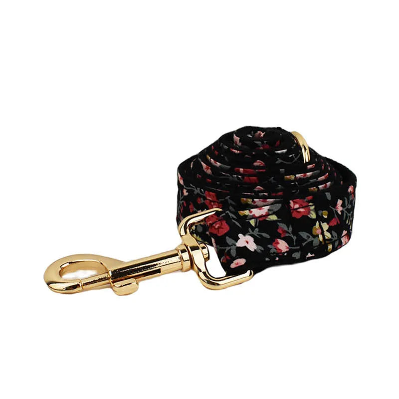 Four-piece pet accessory set showing dog collar, matching leash, decorative bow, and dog vest with cute printed lettering