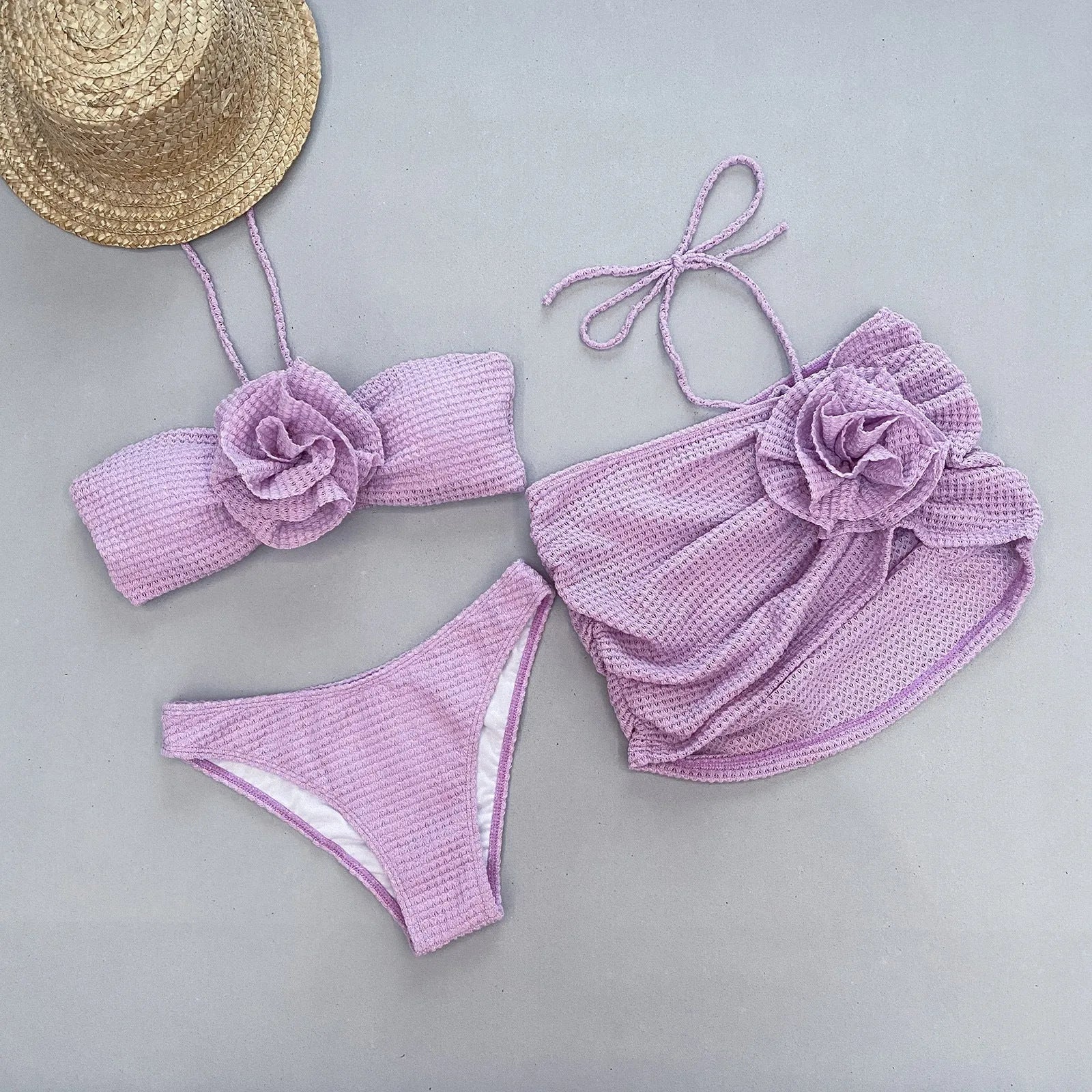 Women's white and purple 3D flower split three-piece bikini set with skirt, bra, and briefs.