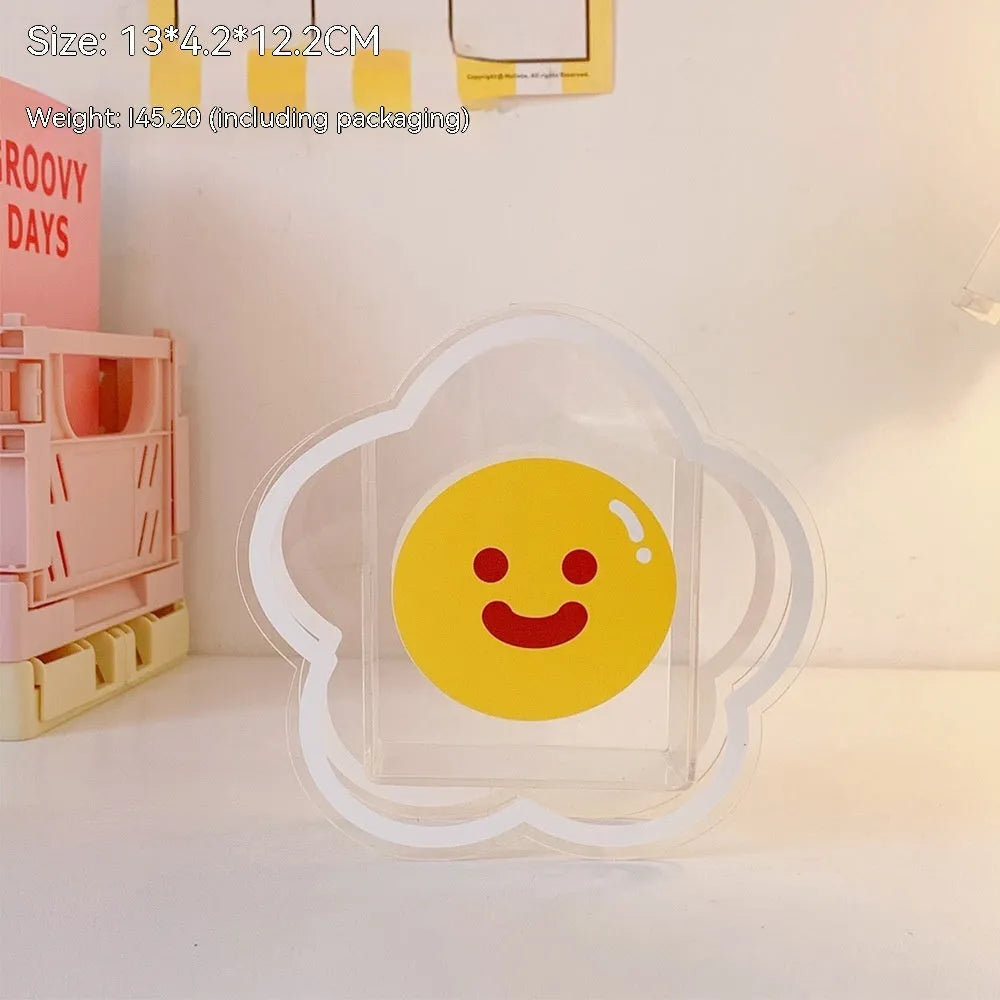Clear square acrylic storage box with a cute strawberry rabbit character design on a desk.