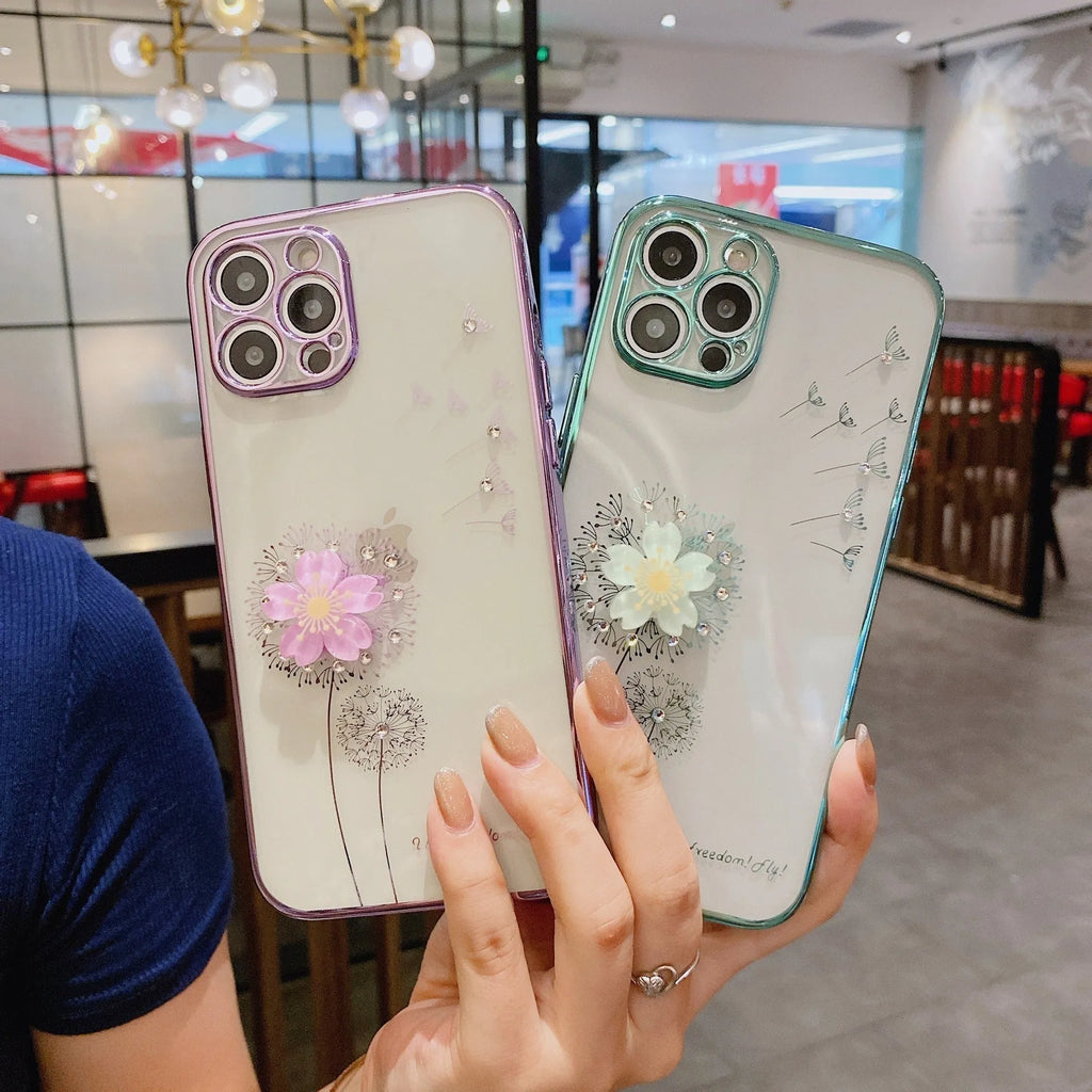 Purple silicone iPhone case with a 3D floral design and built-in spin stand on a table.