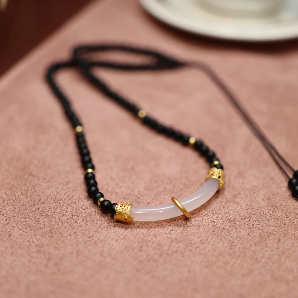Frosted black agate pendant necklace with white chalcedony detailing on 925 silver chain