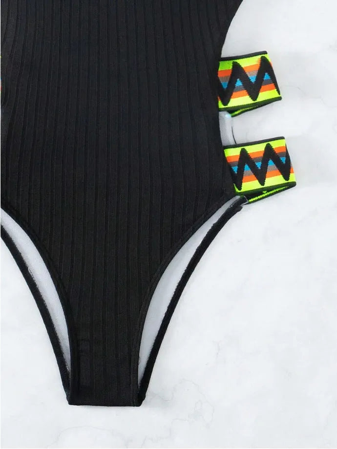 Women's solid colour one-piece swimsuit bikini in black or orange.