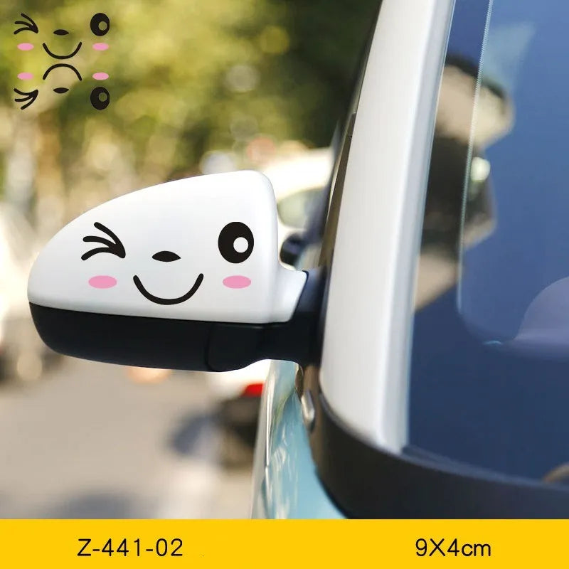 Pair of reflective cartoon car stickers with cute eye designs on a white background.