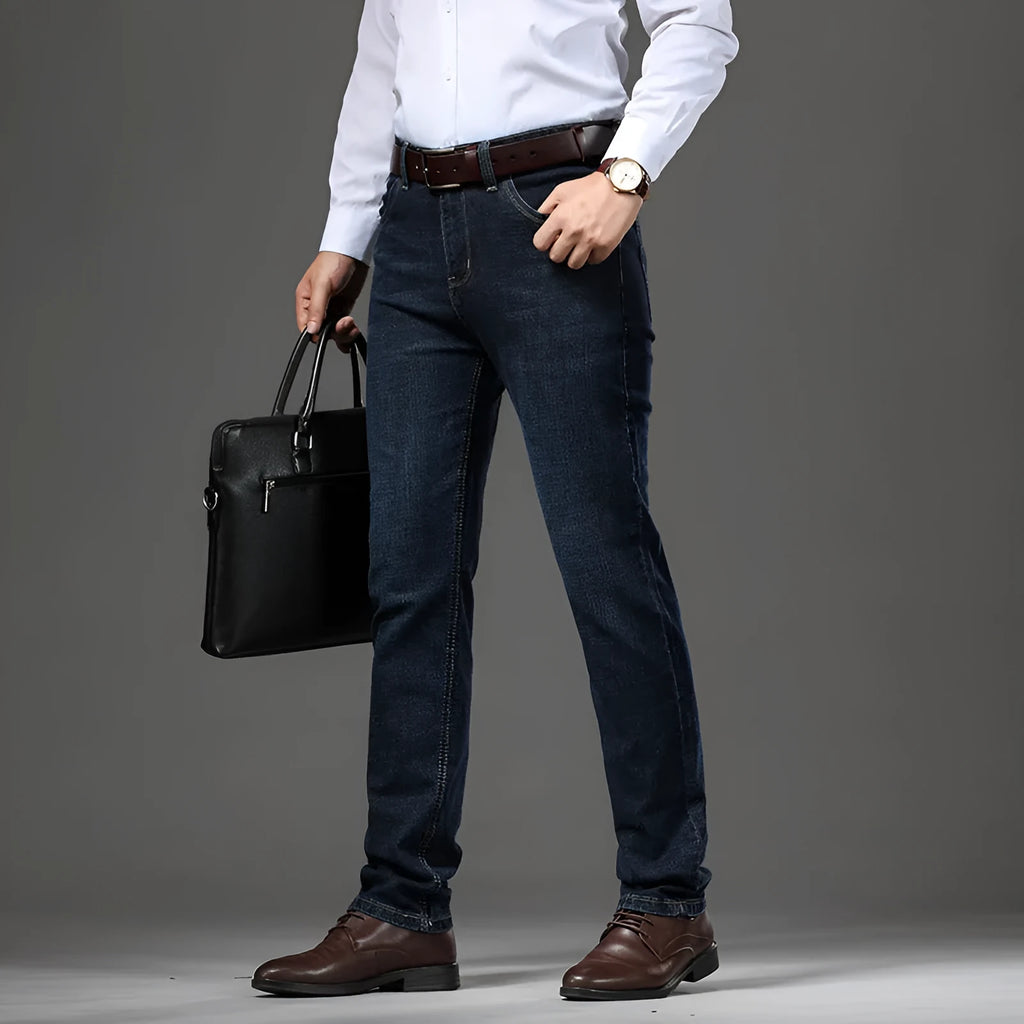 Straight leg stretch jeans in blue denim on a mid-waist model, showing zip fly and high elasticity fabric.