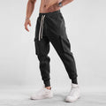 Men's loose cotton ankle-tied sport trousers in a solid colour with multiple pockets.