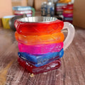 Painted resin decorative cup with library design, measuring 13cm tall with removable book mark element