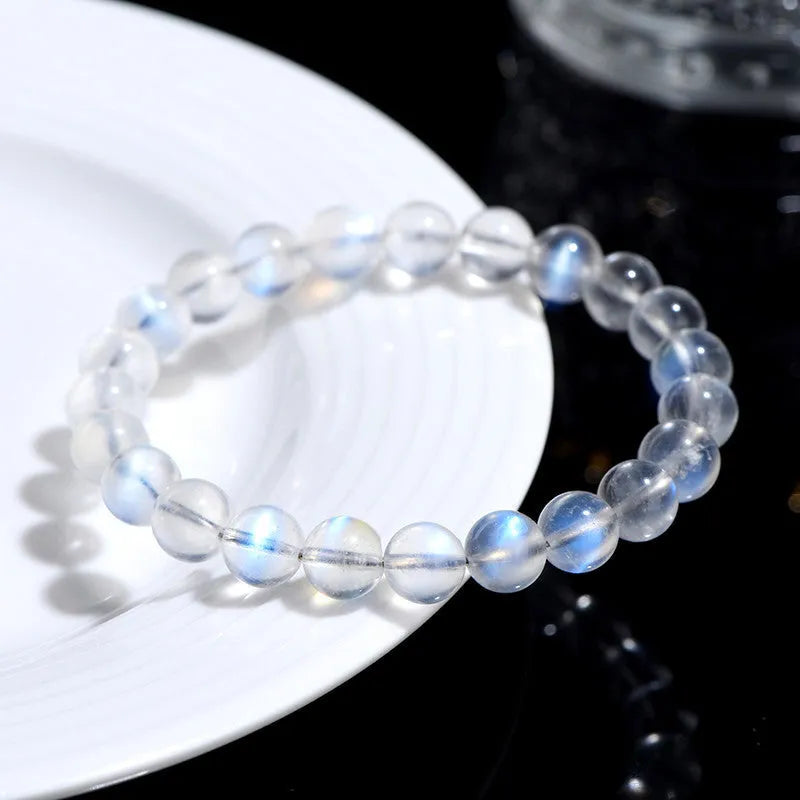 Natural cream body blue moonlight crystal bracelet showing grinding finish on wrist, available in single circle, strip or three ring designs.