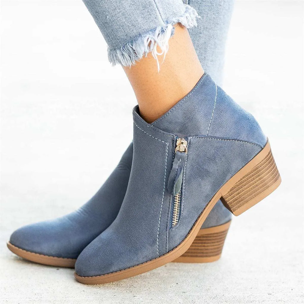 Women's suede ankle boots with side zip and chunky heel in beige, shown from the side.