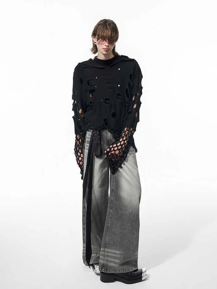Black men's hollow knit hoodie with pearl decoration on the hood, showing loose fit.