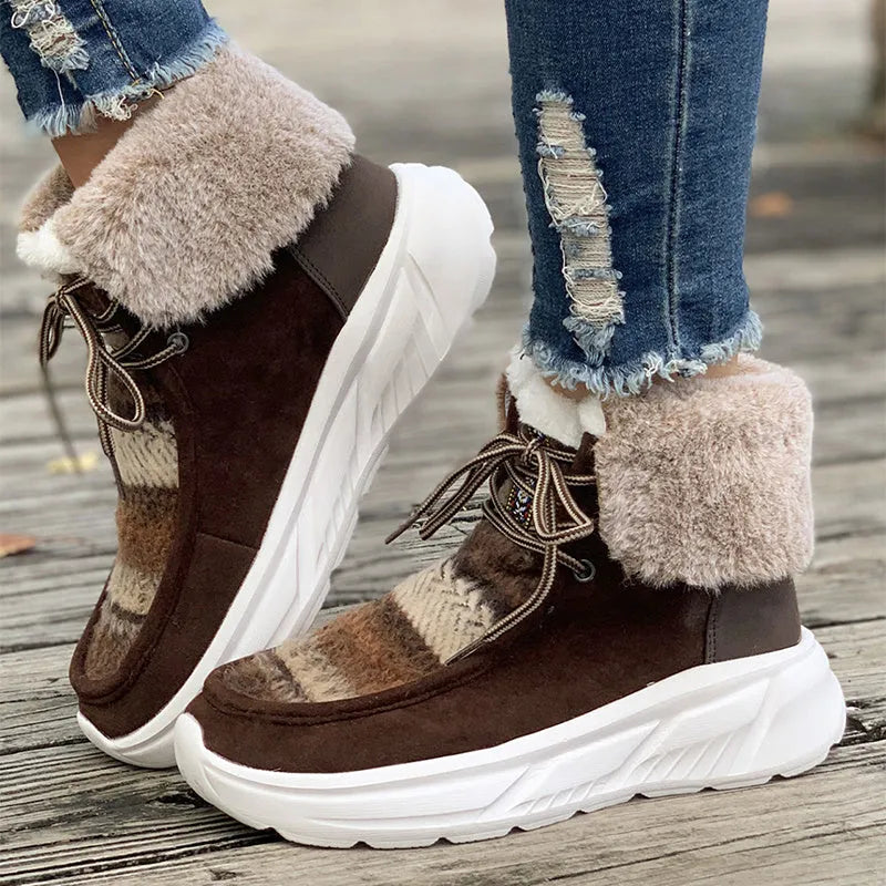Women's mid-top lace-up snow boots in suede with a thick platform sole and plush lining.