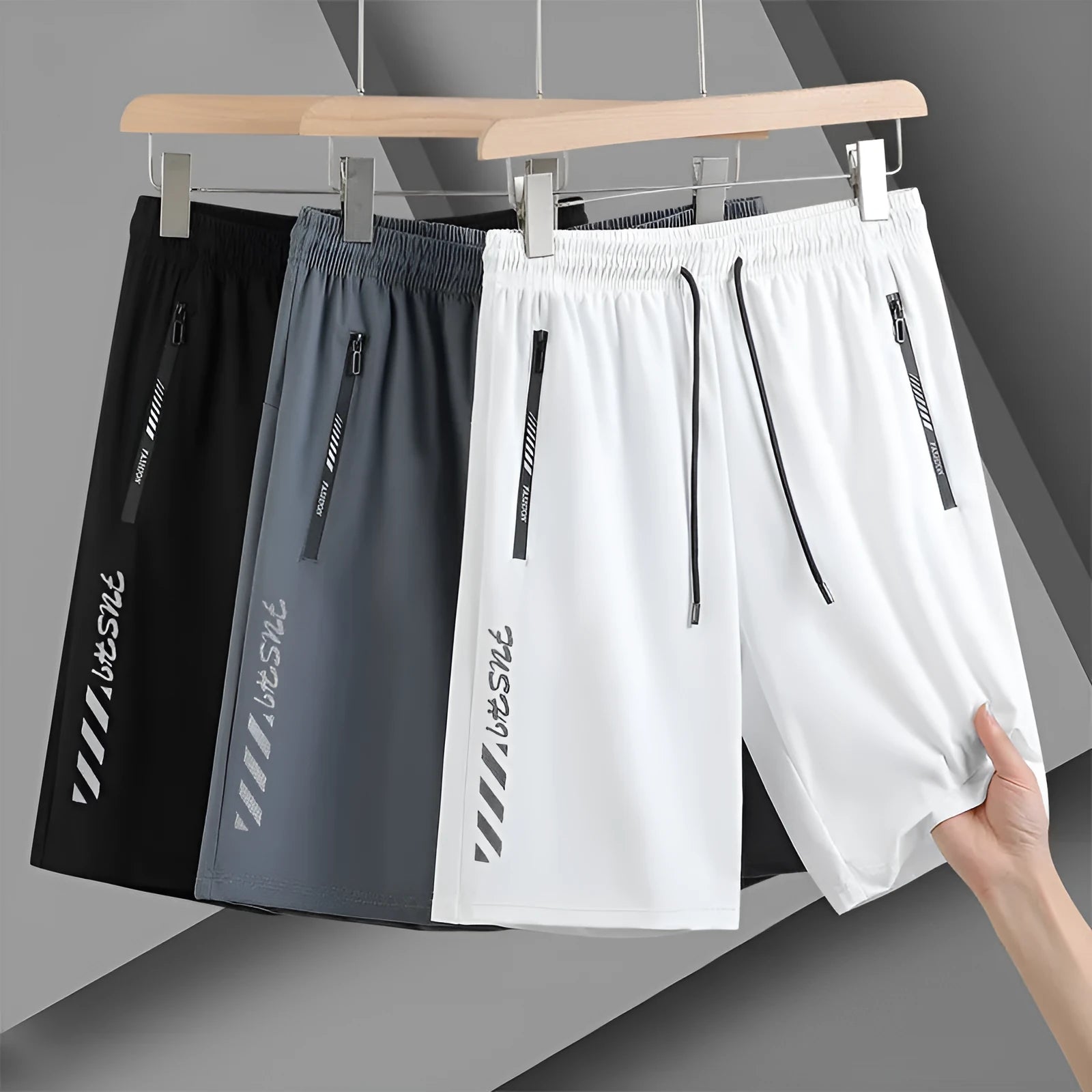 Man's black loose-fit quick-dry nylon sports shorts with elastic waistband on a plain background.
