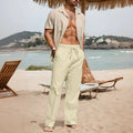 Men's beige cotton linen trousers with drawstring waist and straight legs on a plain background