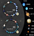 Set of two natural stone beaded bracelets with zodiac sign charms on a white background.