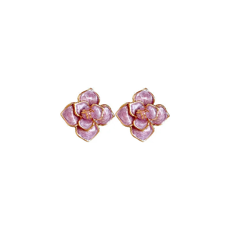 A pair of gold-plated purple flower stud earrings with an oil-spot glaze texture on a white background.
