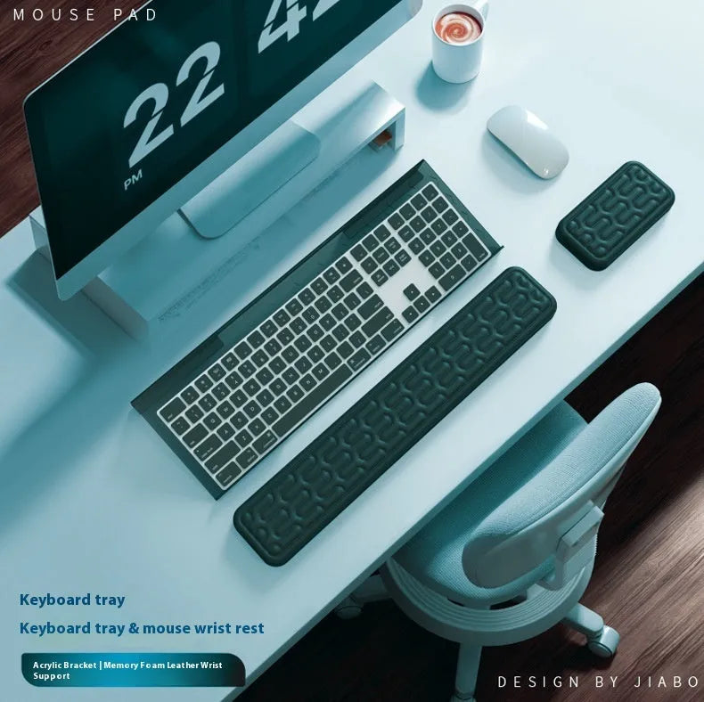 Double-sided keyboard and mouse pad with memory foam wrist rest on a resin base.